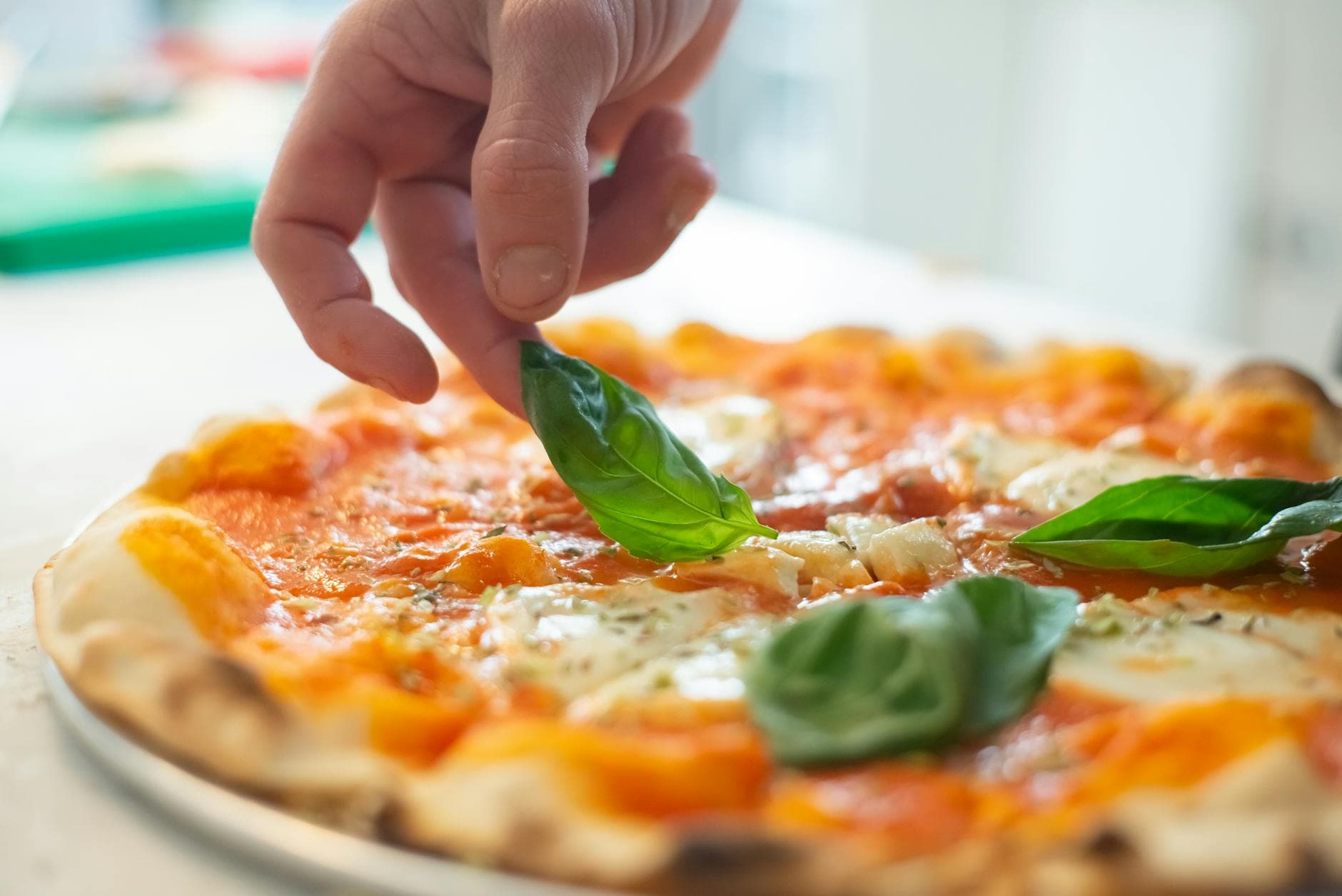 Fresh brick-oven pizza with basil